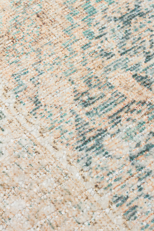 Load image 1 in gallery view. Close-up of a textured rug with a distressed, abstract pattern in cream, teal, and soft orange tones.