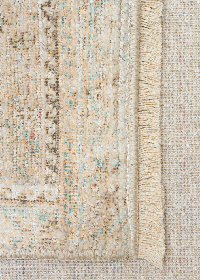 Beige and cream distressed rug with teal accents, traditional border pattern, and fringed edge.