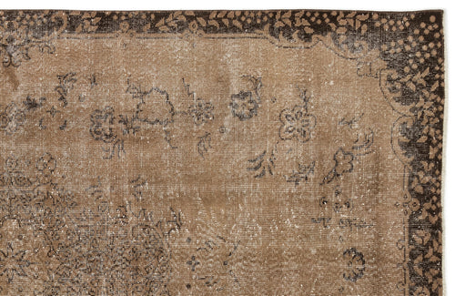 Load image 1 in gallery view. Distressed brown and dark brown rug with a faded floral border and scattered botanical motifs.