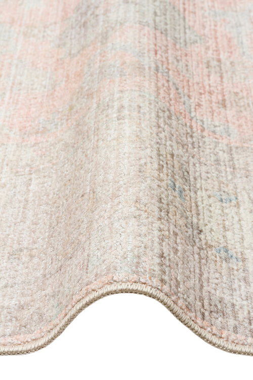 Bild 1 in Galerieansicht laden. Distressed beige and soft pink rug with a faded traditional medallion pattern, shown in a close-up folded view.