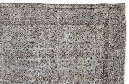 Load image 1 in gallery view. Grey and charcoal distressed rug with a traditional floral medallion pattern and a bordered edge.