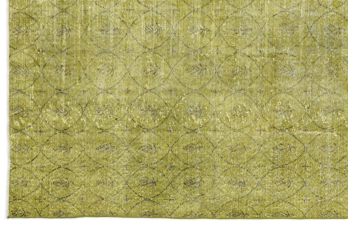 Olive green rug with a distressed, repeating circular lattice pattern.