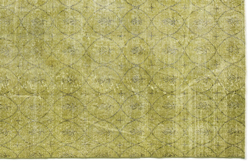Load image 1 in gallery view. Olive green distressed rug with a repeating dark geometric circle and diamond pattern.
