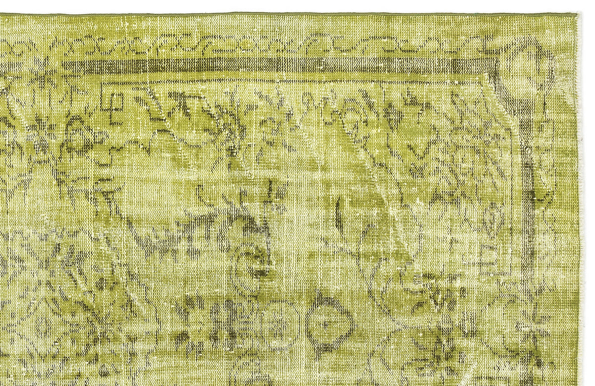 Chartreuse and olive green vintage-style rug with a distressed traditional medallion pattern on a white background.