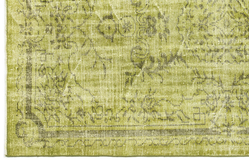 Load image 1 in gallery view. Chartreuse and olive green distressed rug with a faded traditional floral medallion pattern.