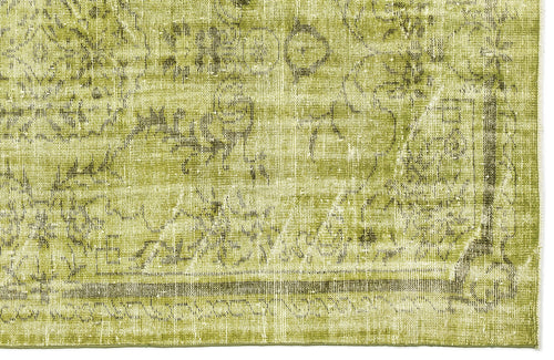 Load image 1 in gallery view. Chartreuse and olive green rug with a distressed, faded traditional floral medallion pattern.