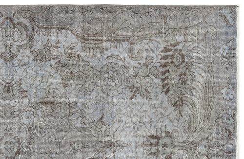 Load image 1 in gallery view. Grey and charcoal distressed rug with a faded traditional floral medallion pattern on a white background.