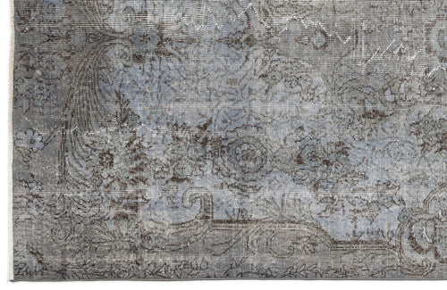 Load image 1 in gallery view. Blue and charcoal grey rug with a distressed, faded floral medallion pattern and a fringed edge.