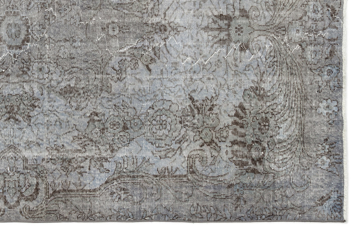 Grey and slate blue distressed rug with a traditional floral medallion pattern.