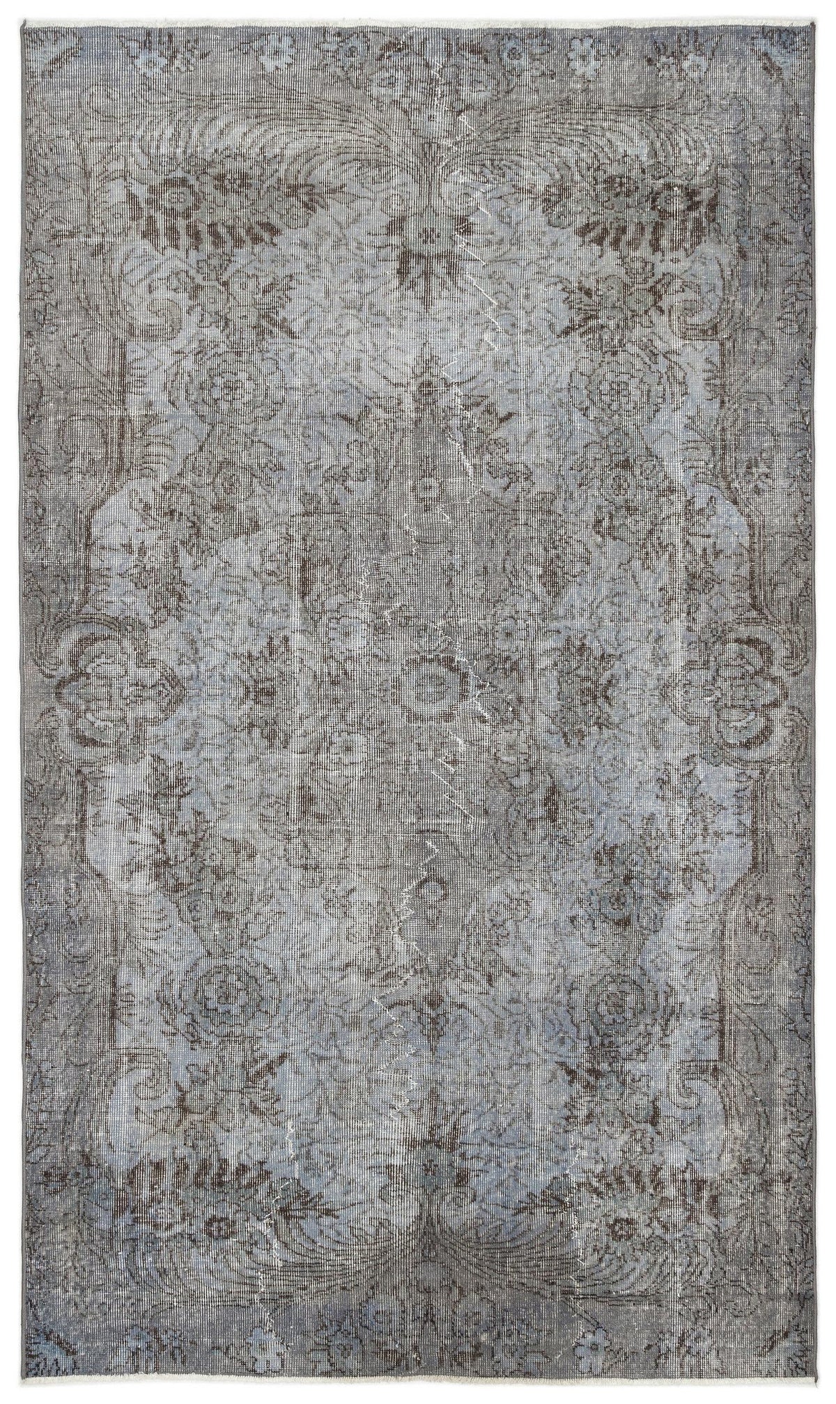 Grey and slate blue distressed traditional rug with a faded floral medallion pattern.