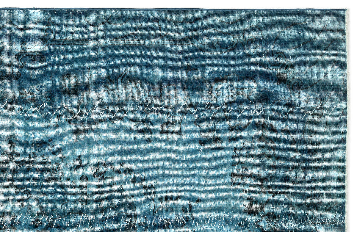 Teal and blue distressed rug with a faded traditional floral medallion pattern on a white background.
