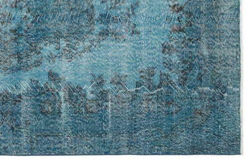 Load image 1 in gallery view. Teal and black distressed rug with a faded traditional floral medallion pattern.