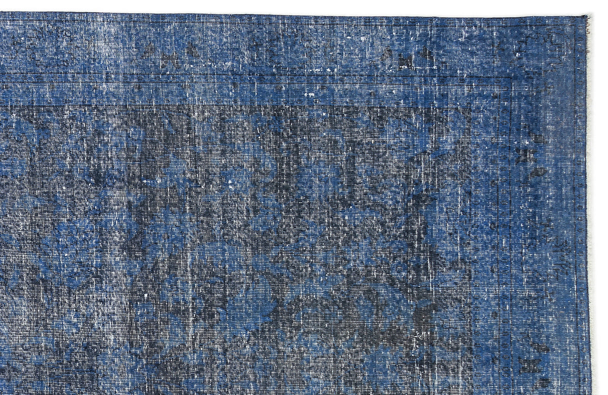 Navy blue and black distressed traditional rug with a faded, worn-in texture and a bordered medallion pattern.