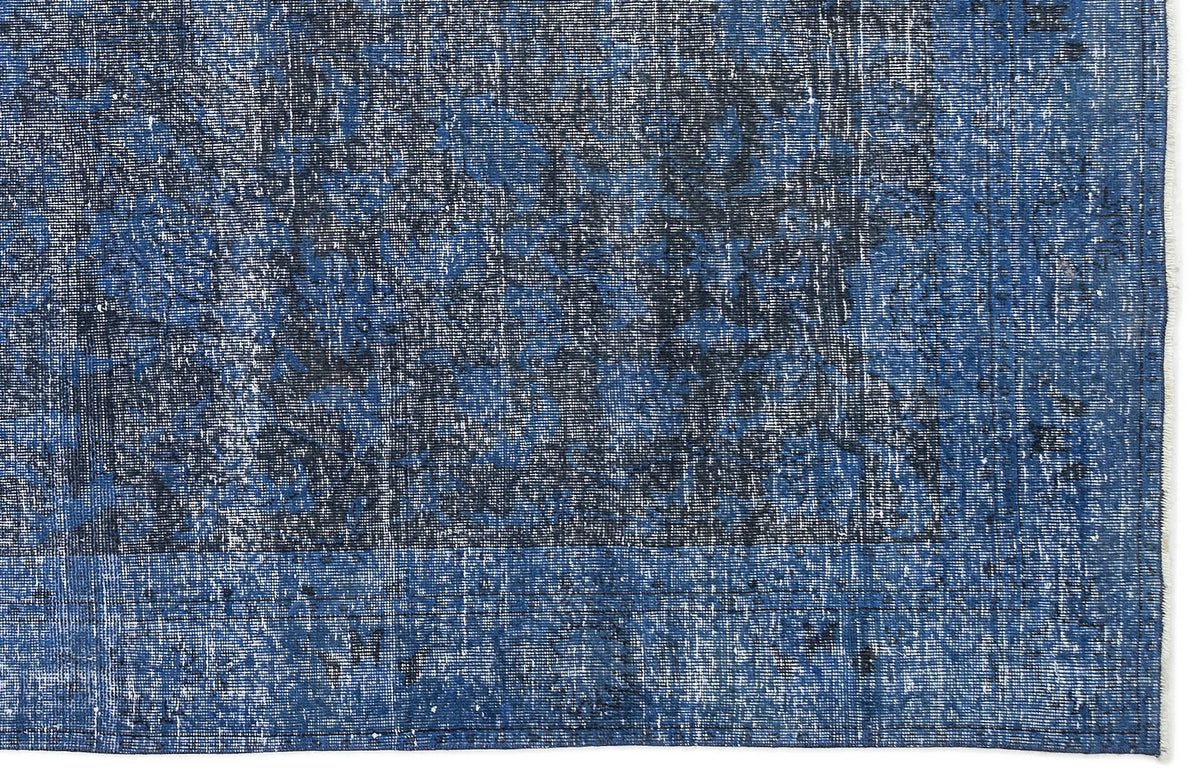 Navy and royal blue distressed rug with a faded traditional medallion pattern and a bordered edge.