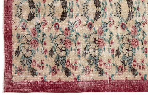 Load image 1 in gallery view. Beige rug with a distressed floral pattern in red, teal, and brown, featuring a solid red border.