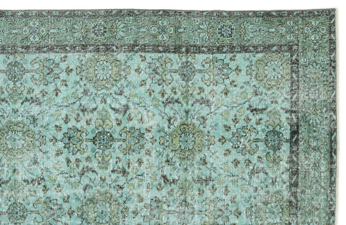 Load image 1 in gallery view. Distressed teal and olive green rug with a traditional floral medallion pattern and a dark border.