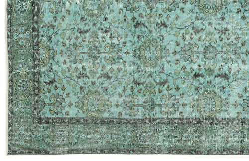 Load image 1 in gallery view. Distressed turquoise and olive green rug with a traditional floral medallion pattern and a dark border.