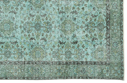 Load image 1 in gallery view. Distressed teal and olive green rug with a traditional floral medallion pattern and a dark border.