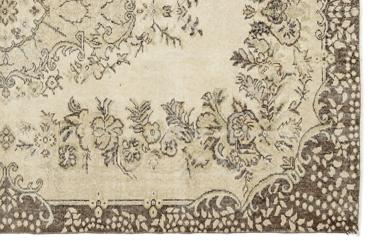 A close-up of the Coveis Vintage Medallion Rug (5'10" x 9'4") displays intricate floral and vine patterns in brown and beige, highlighted by a decorative border and detailed vintage design elements.