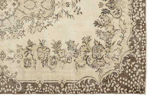 Load image 1 in gallery view. A close-up of the Coveis Vintage Medallion Rug (5'10" x 9'4") displays intricate floral and vine patterns in brown and beige, highlighted by a decorative border and detailed vintage design elements.
