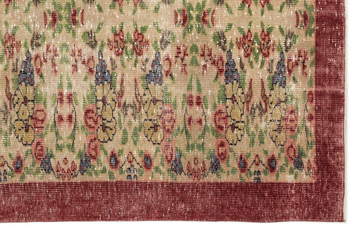 Load image 1 in gallery view. Distressed beige rug with a multi-colored floral pattern in red, green, and blue, featuring a solid dark red border.