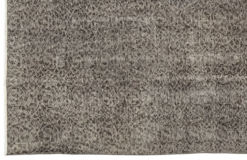 Load image 1 in gallery view. Charcoal and grey distressed rug with a faded, traditional floral medallion pattern.