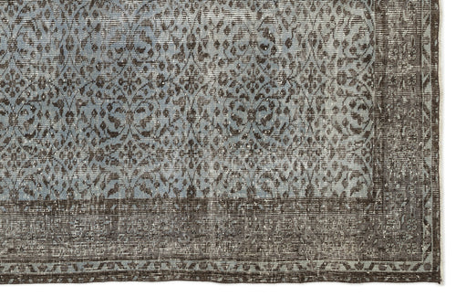 Load image 1 in gallery view. Blue and charcoal grey rug with a distressed, traditional floral medallion pattern and a wide decorative border.