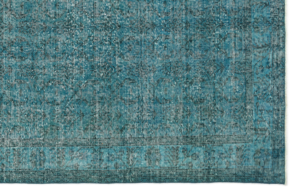 Teal and dark blue distressed rug with a faded traditional medallion pattern.