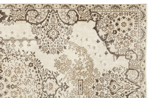 Load image 1 in gallery view. Beige and dark brown rug with a distressed traditional floral medallion pattern.