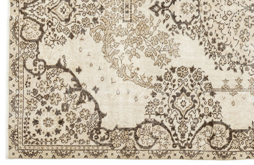Load image 1 in gallery view. Beige and dark brown traditional rug with a distressed floral medallion pattern.