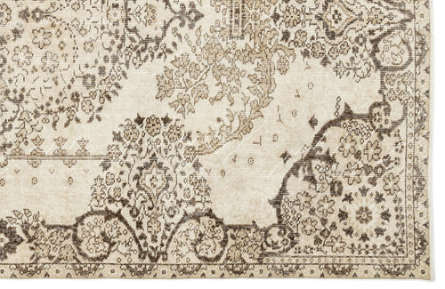 Load image 1 in gallery view. Beige and dark brown rug with a distressed, traditional floral medallion pattern.