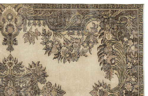 Load image 1 in gallery view. Beige and brown traditional rug with a floral medallion pattern and a geometric Greek key border.