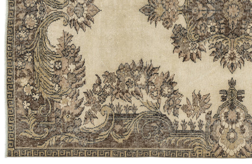 Load image 1 in gallery view. Beige and brown traditional rug with a distressed floral pattern and a geometric border.