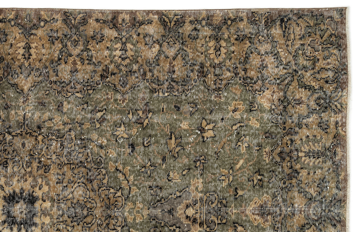 Olive green and brown distressed rug with a faded traditional floral medallion pattern.