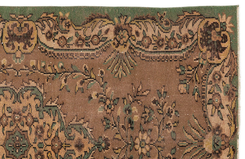 Load image 1 in gallery view. Brown and green traditional rug with a floral medallion border and intricate botanical motifs.