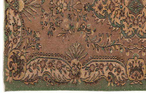 Load image 1 in gallery view. Brown traditional rug with a distressed floral medallion pattern in green, tan, and dark brown.