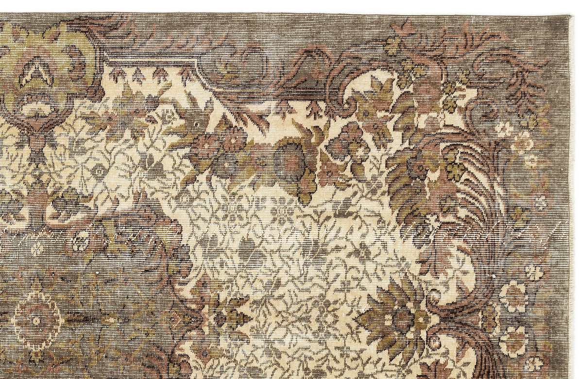 Distressed vintage-style rug with a cream, brown, and olive green floral medallion pattern on a white background.