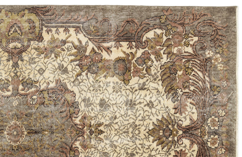 Load image 1 in gallery view. Distressed vintage-style rug with a cream, brown, and olive green floral medallion pattern on a white background.