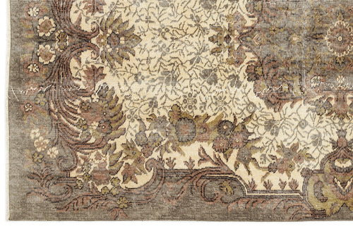 Load image 1 in gallery view. Distressed brown, olive, and cream rug with an intricate traditional floral medallion pattern.