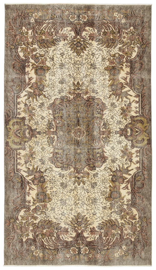 Load image 1 in gallery view. Distressed brown, olive, and cream rug with a traditional floral medallion pattern and ornate border.