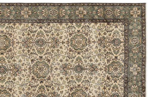 Load image 1 in gallery view. Sage green, brown, and cream traditional rug with a repeating floral medallion pattern and a wide decorative border.