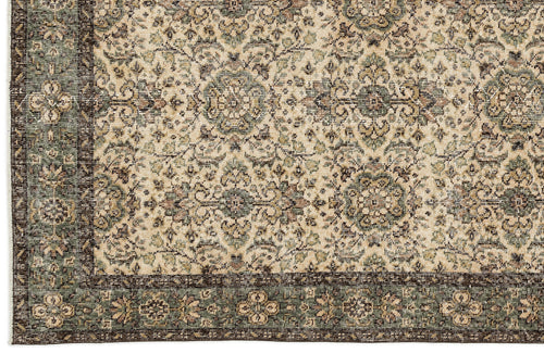 Load image 1 in gallery view. Beige, sage green, and dark brown traditional rug with a distressed floral medallion pattern and a wide border.