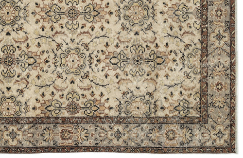 Load image 1 in gallery view. Beige and brown traditional rug with a distressed floral medallion pattern and a detailed border.