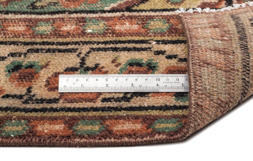 Load image 1 in gallery view. Close-up of a brown, tan, and green patterned rug with a metal ruler showing pile height, isolated on white.