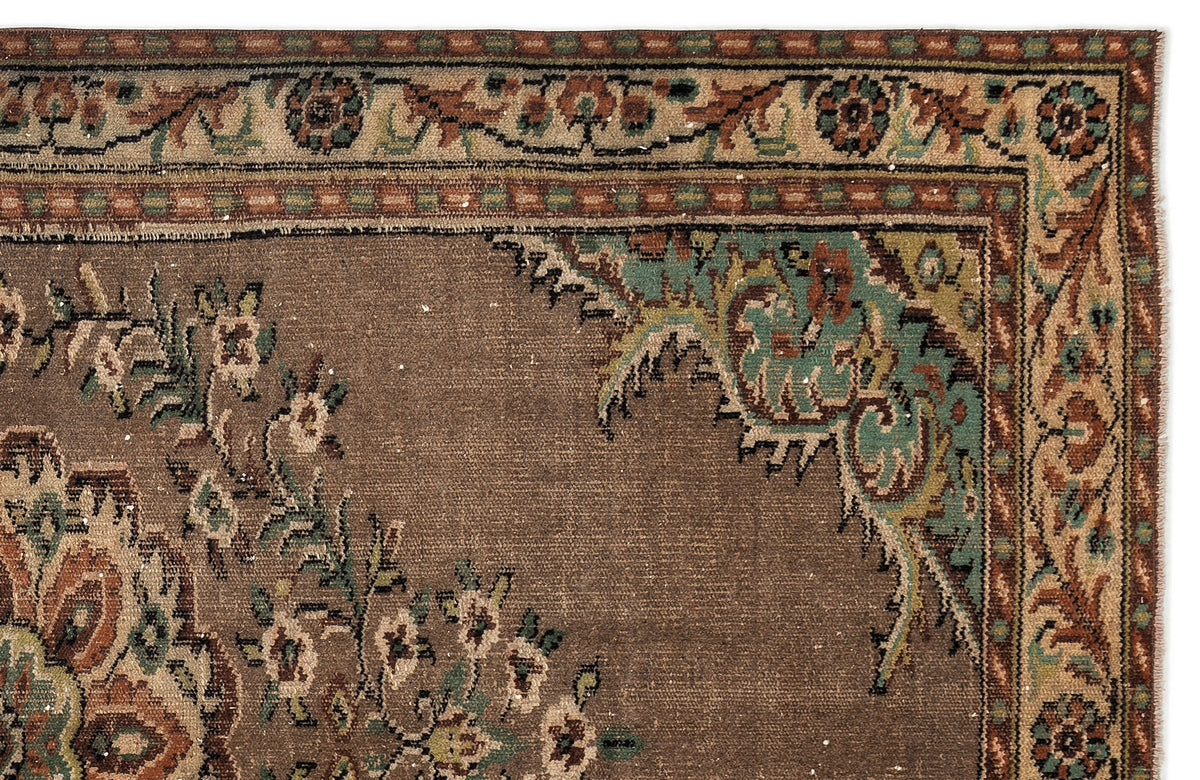 Brown traditional rug with a teal and rust floral border and corner medallion detail on a white background.