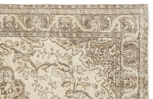 Load image 1 in gallery view. A close-up of the Tribuva Vintage Medallion Rug (6'3 x 9'6) highlights its intricate floral and geometric patterns in beige and brown, featuring detailed border and central medallion designs.
