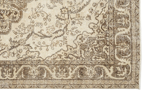 Load image 1 in gallery view. A close-up of the Tribuva Vintage Medallion Rug (6'3" x 9'6"), showcasing its rectangular shape, traditional floral and vine motifs in beige and brown, decorative border, and intricate vintage-inspired detailing.