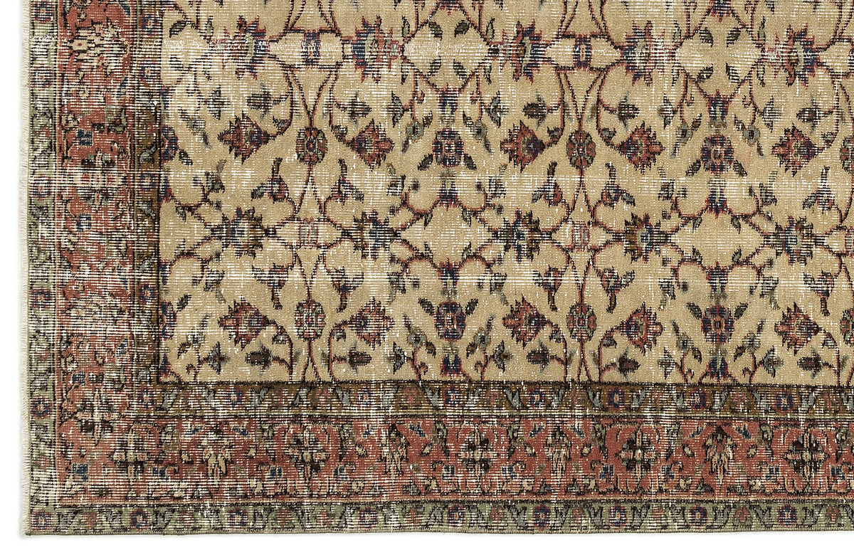Beige rug with a distressed floral vine pattern in red, blue, and green, featuring a wide decorative border.