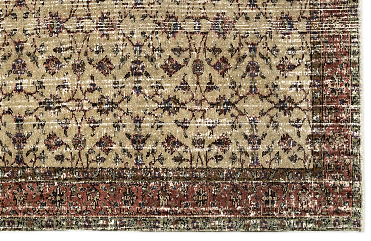 Beige rug with a distressed floral vine pattern in red, blue, and green, featuring a wide decorative border.