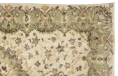 Load image 1 in gallery view. Sage green, beige, and brown vintage-style rug with a floral medallion border and scattered botanical motifs.